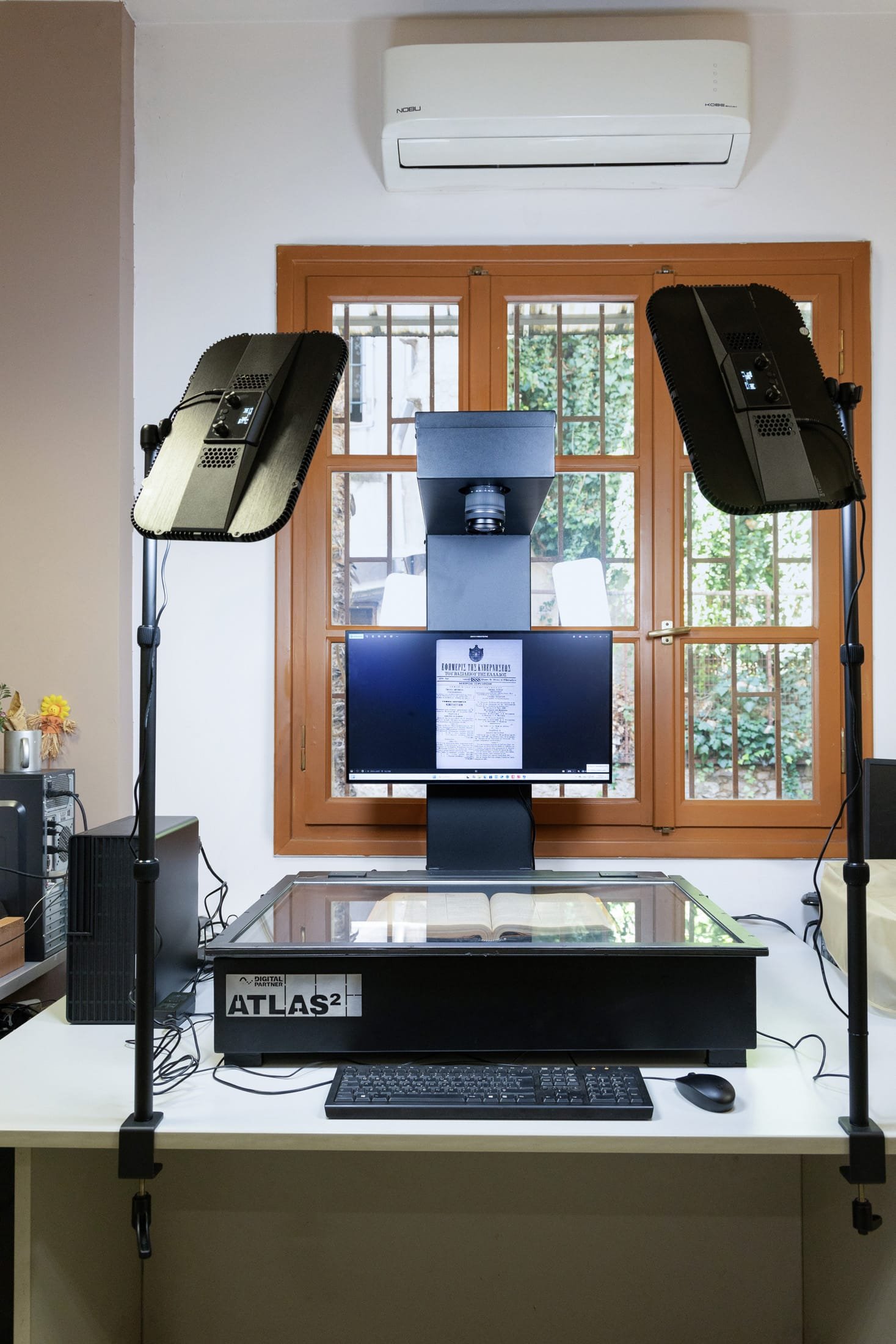 Photo of the Atlas 2 scanner in an office setting, a window on the background